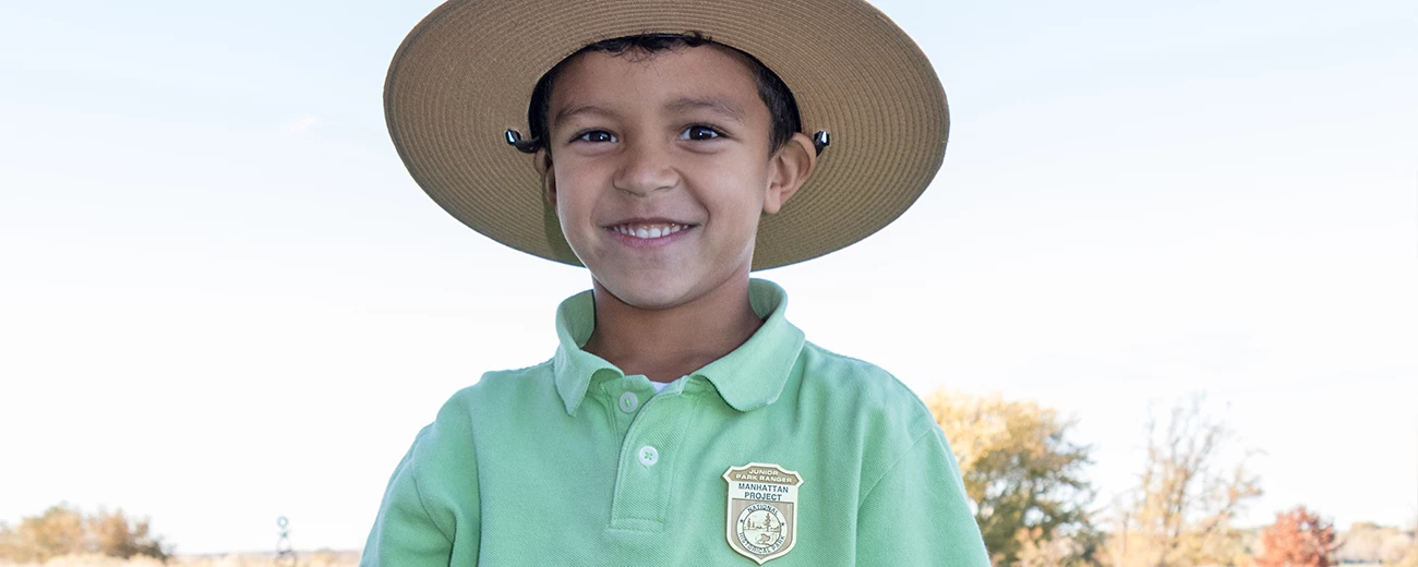 MAPR Junior Ranger A young boy is wearing a ranger hat and a junior ranger badge on his shirt.