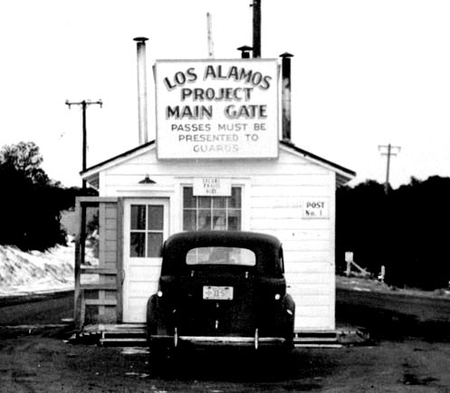 Los Alamos Gate black and white image with car parked at a small building