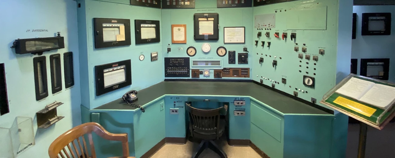 X-10 Graphite Reactor Control Room A green office desk with dials and knobs along the walls.