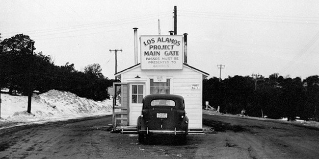 historic image of the entrance gate at the Los Alamos site historic image of the entrance gate at the Los Alamos site