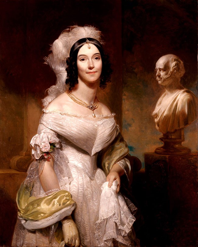 Portrait of a woman (Angelica Van Buren) in a white dress with a bust of Van Buren in the background