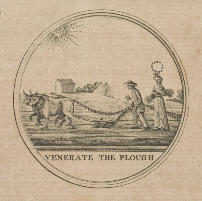 Printed Image of Farmer ploughing a field with the text "Venerate the Plough" Underneath