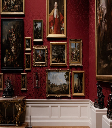 Assorted eighteenth and nineteenth century paintings on a musuem gallery wall.