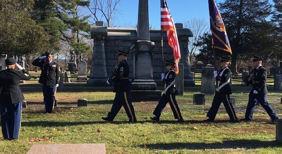 Ceremony at Martin Van Buren's Graveside An honor guard marching in formation in front of a grave shaped like an obelisk