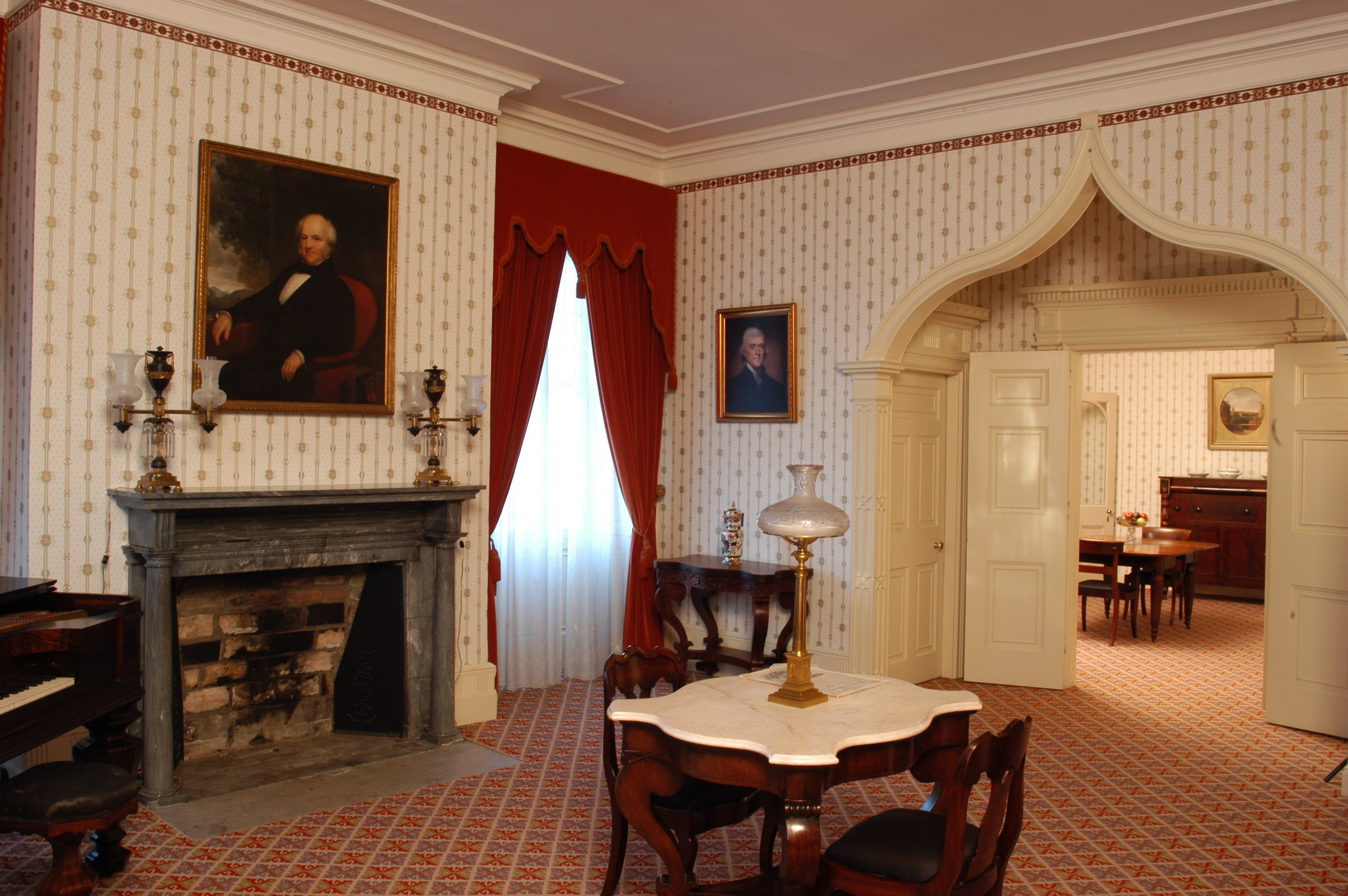 Formal Parlor at Lindenwald A finely decorated room with a table in the center and a portrait over the fireplace