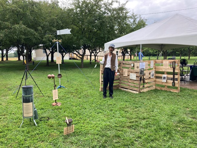 A man displays historic weather instruments.