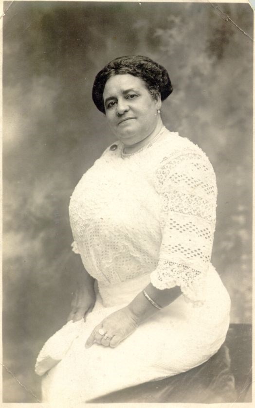 woman in a white dress looking at the camera
