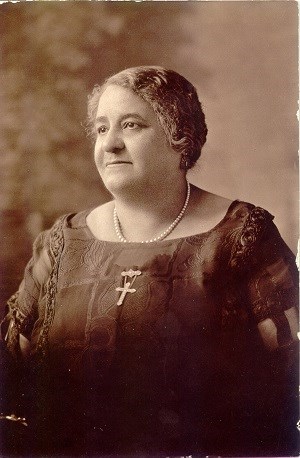 Maggie Walker portrait wearing a dark dress and cross necklace