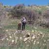 Archeologist in the field documenting a collapsed pueblo.