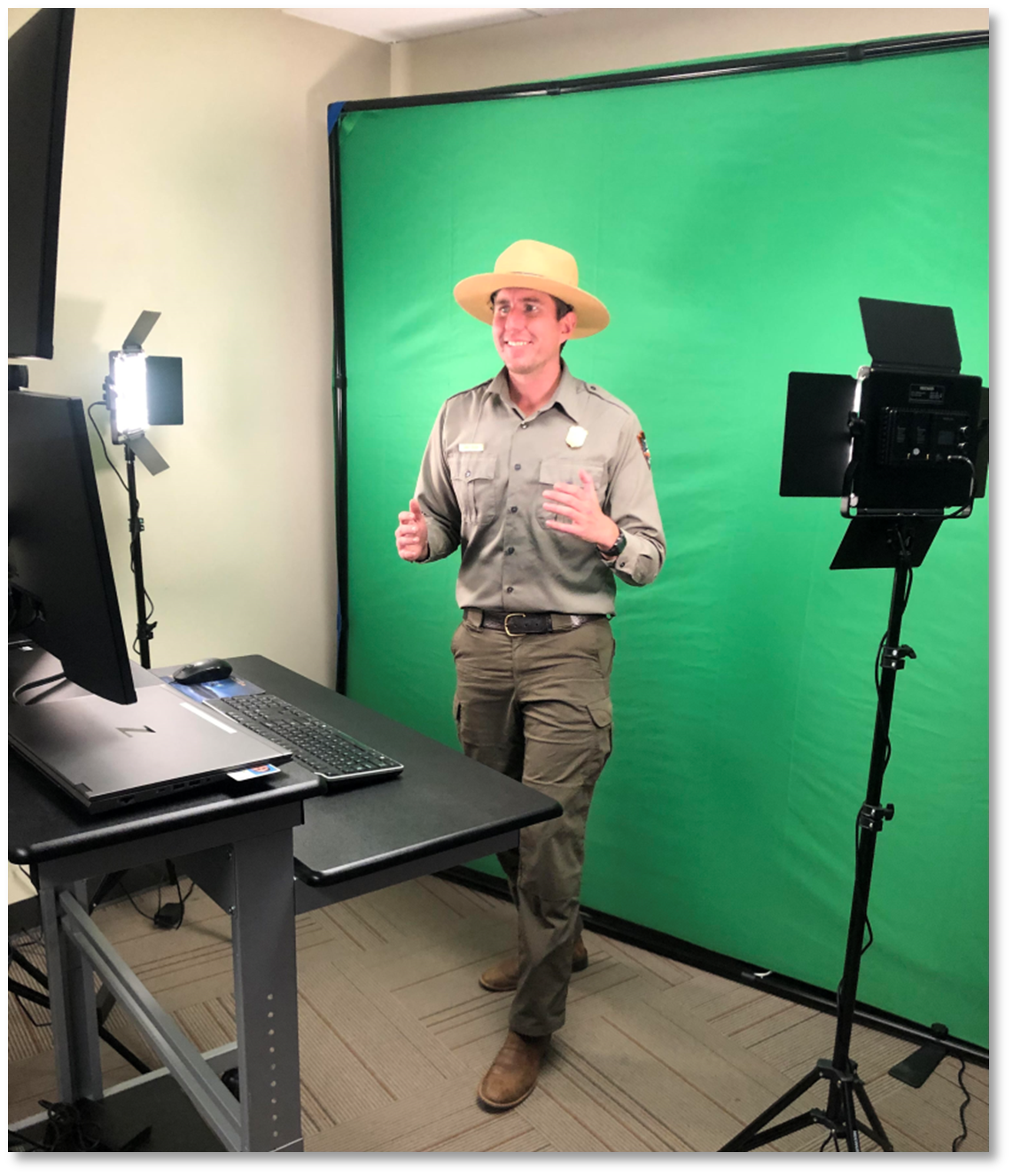 Ranger presents a program on camera in front of a green screen.