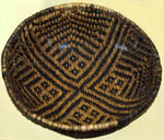 Tan basket with dark geometric lines. Tan basket with dark geometric lines.
