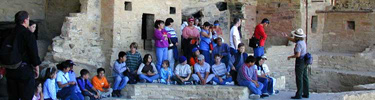 Visitors in the kiva courtyard of Balcony House