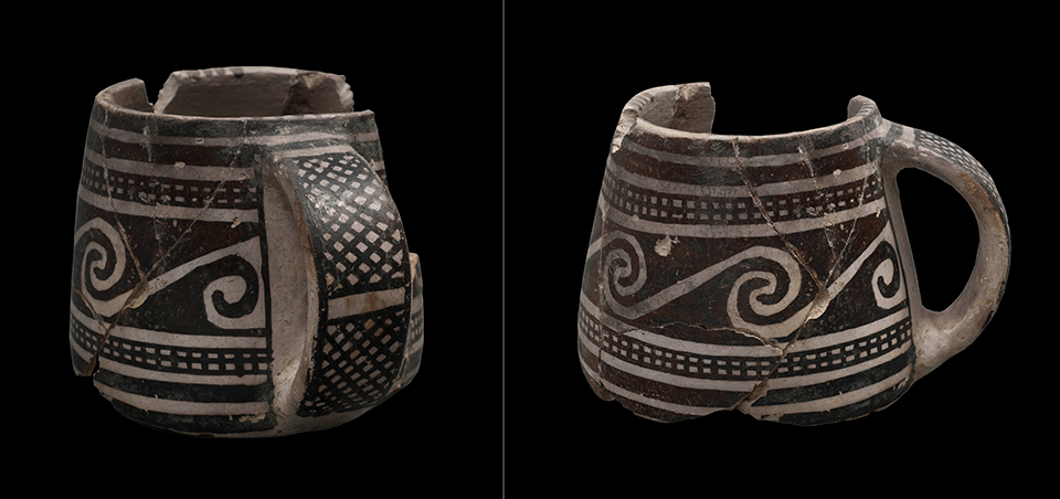 White mug with black, painted geometric designs