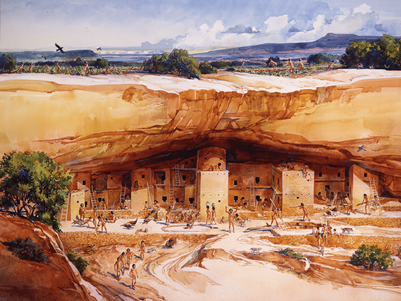 A stonework village in a cliffside. People work and children play in the village as people farm on the mesa above.