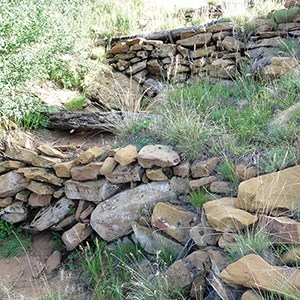 Small walls built with sandstone blocks arranged in a terraced fashion.