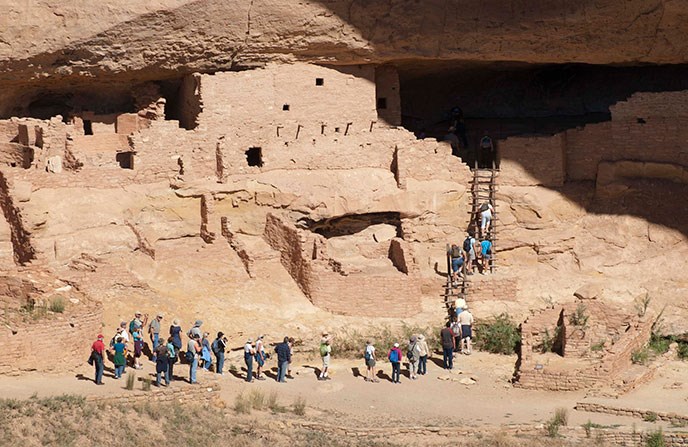 View of visitors on a tour of Long House