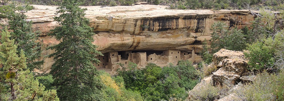 View of stone-masonry pueblo within a cliff alcove