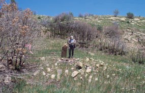 Archeologist documenting a collapsed pueblo.