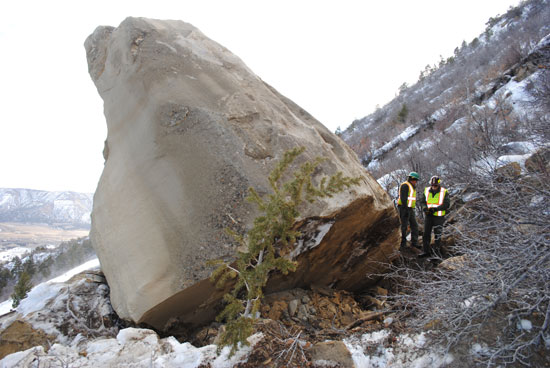 Park staff checking the stability of the 240-ton boulder before blast.