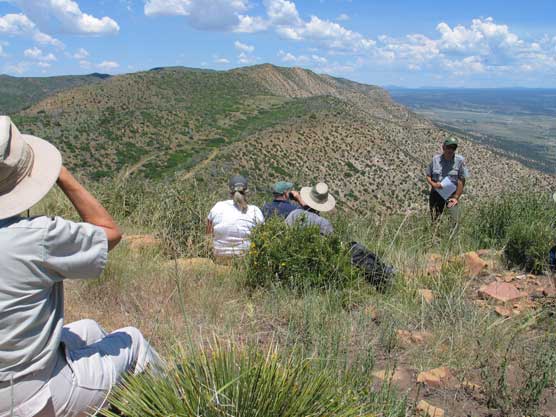 Ranger with small group in Mesa Verde's Wilderness discussing the area.