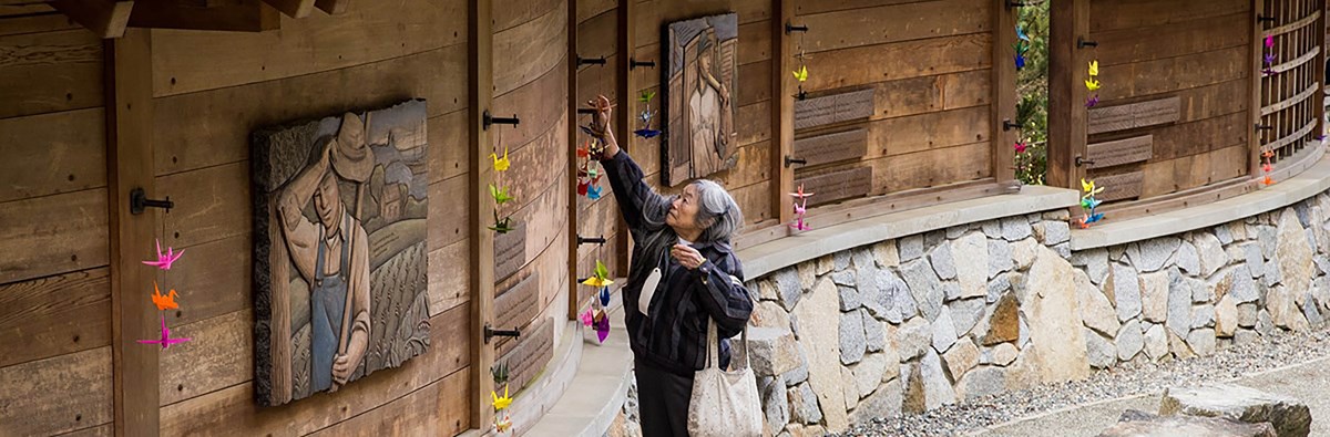 Woman visits memorial wall at Bainbridge Island