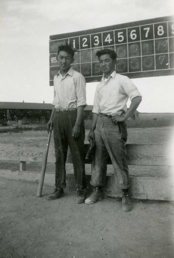 Players posing in front of the score board.