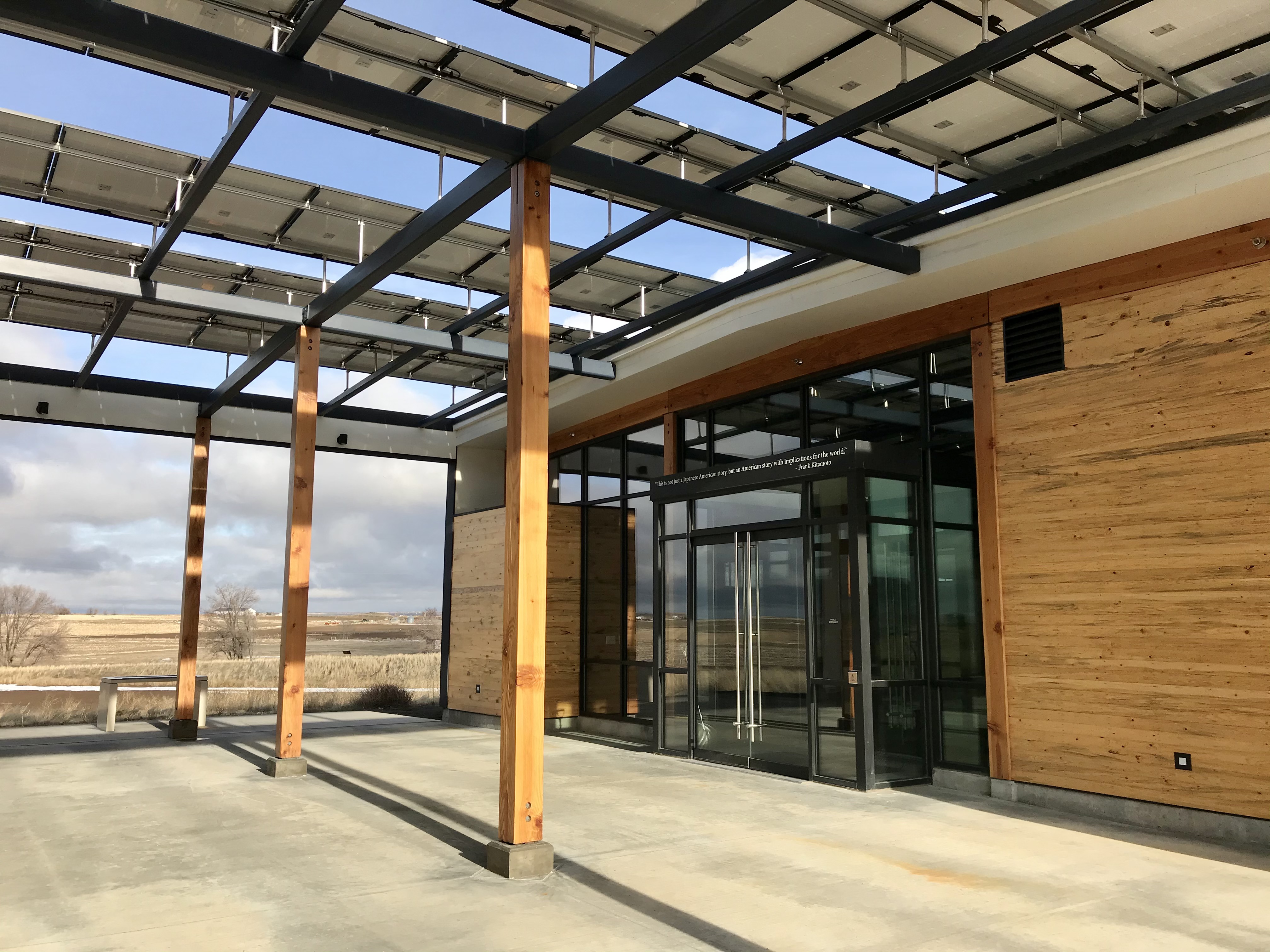 Exterior shot of the patio and glass entrance doors of the Minidoka visitor center.
