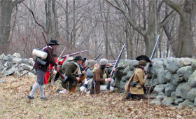 colonial militia take cover behind a wall