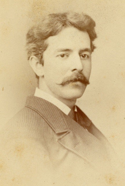 19th Century photograph of a young man with dark hair and broad moustache