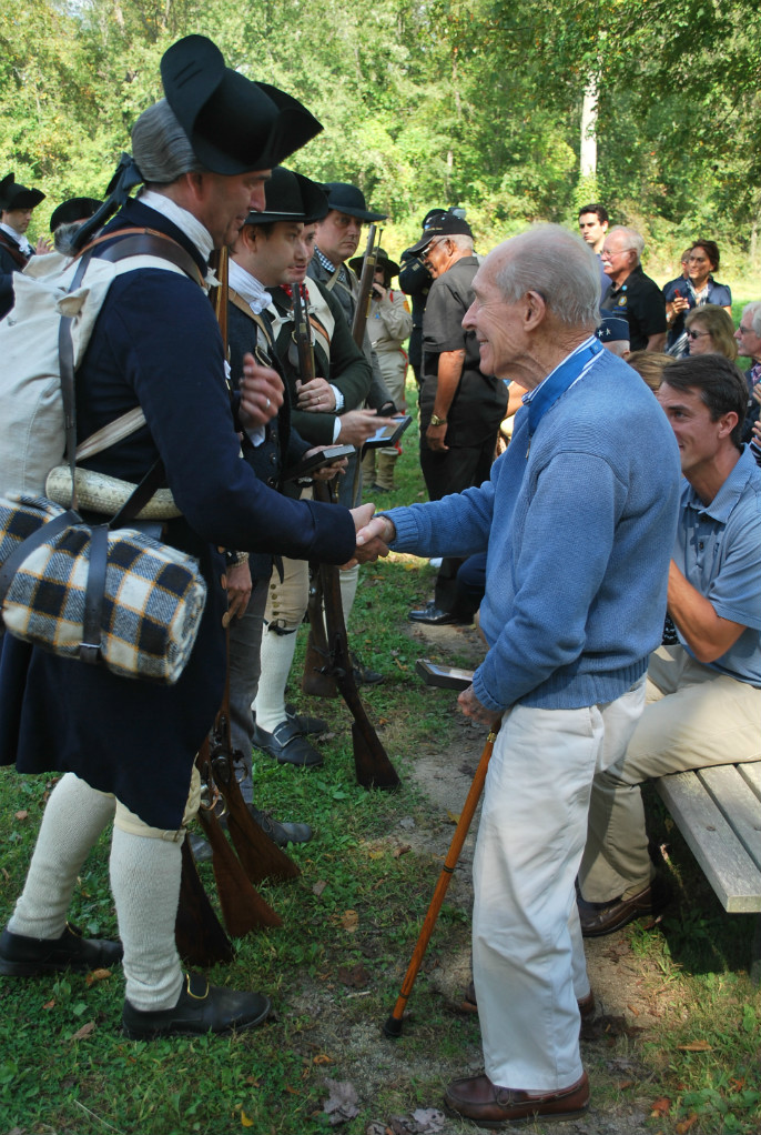 Captain Thomas Hudner shakes hands with historian and park volunteer Joel Bohy