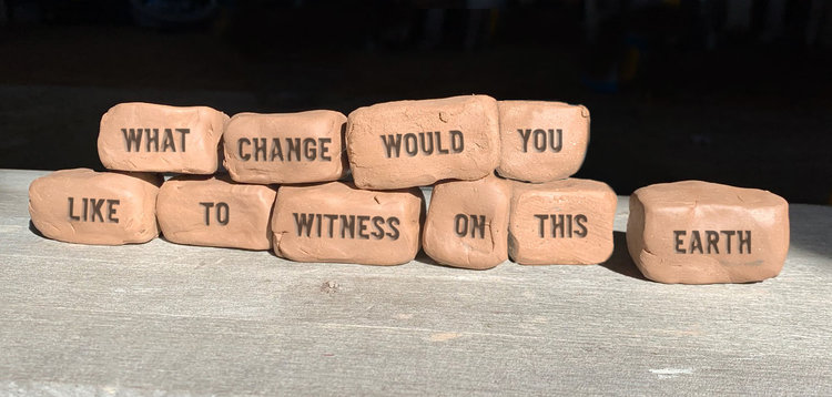 Earth bricks spell out "what changes would you like to witness on this earth" Earth bricks spell out "what changes would you like to witness on this earth"