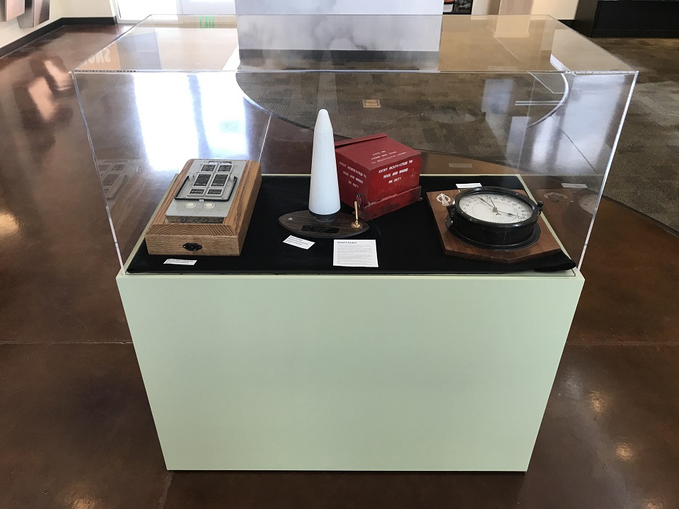 Temporary display case green exhibit case with a clear cover displaying artifacts