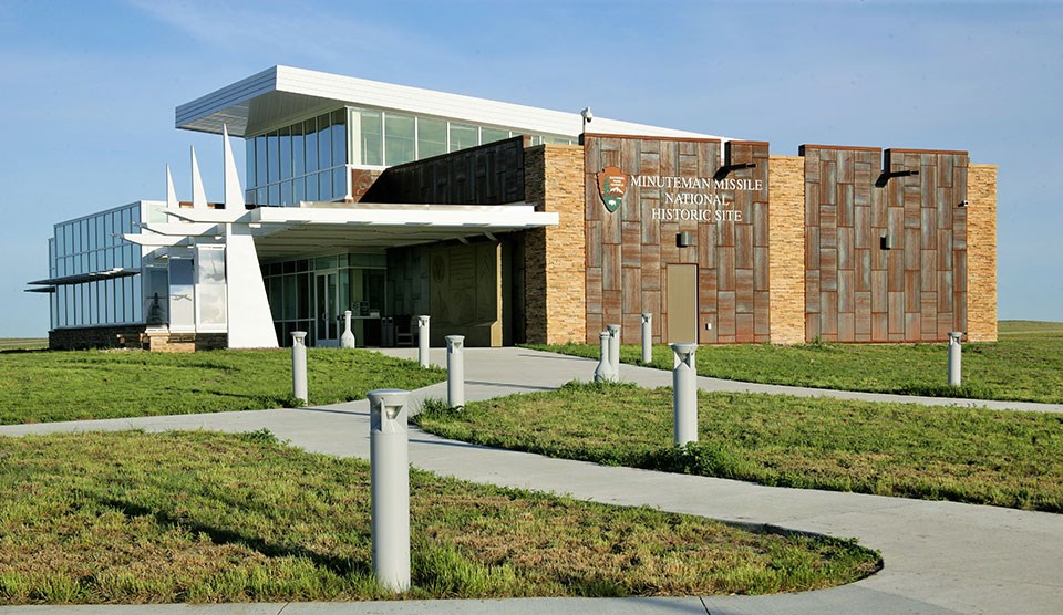 A building with prominent glass windows and steel panels