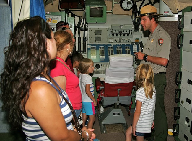 Park ranger talks to visitors in a cramped room Park ranger talks to visitors in a cramped room