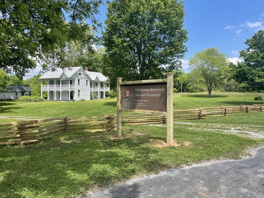 A picture of a white two story house with NPS brown sign in front.
