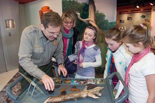 A ranger works with a family.