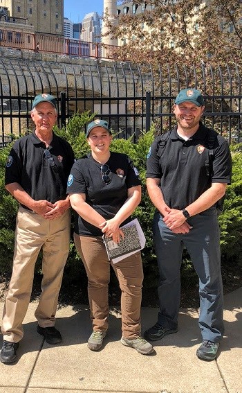 Three people in River Educator shirts.