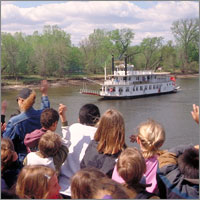 Children waving at Big River Journey event. Children waving at Big River Journey event.