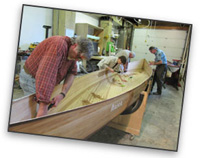 Volunteers working on a canoe at the NorthWest Canoe Company workshop. Volunteers working on a canoe at the NorthWest Canoe Company workshop.