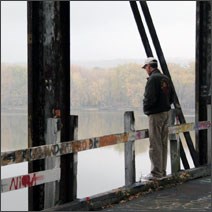 Man viewing the Mississippi River from the Rock Island Bridge.