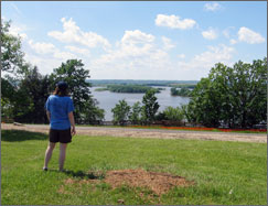 A visitor enjoying a view of the Mississippi River from Schaars Bluff.