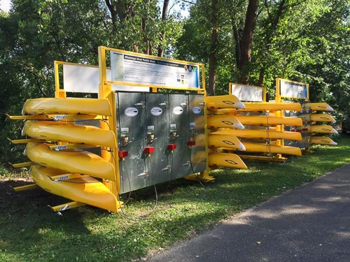 Kayaks sit on a rack. Kayaks sit on a rack.