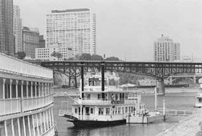 Old picture of the classic boats that set sail off the Harriet Island.