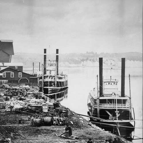 Historic steamboats along the banks of the Mississippi River.