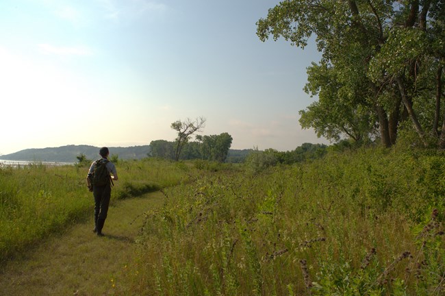 A person hikes down a trail.