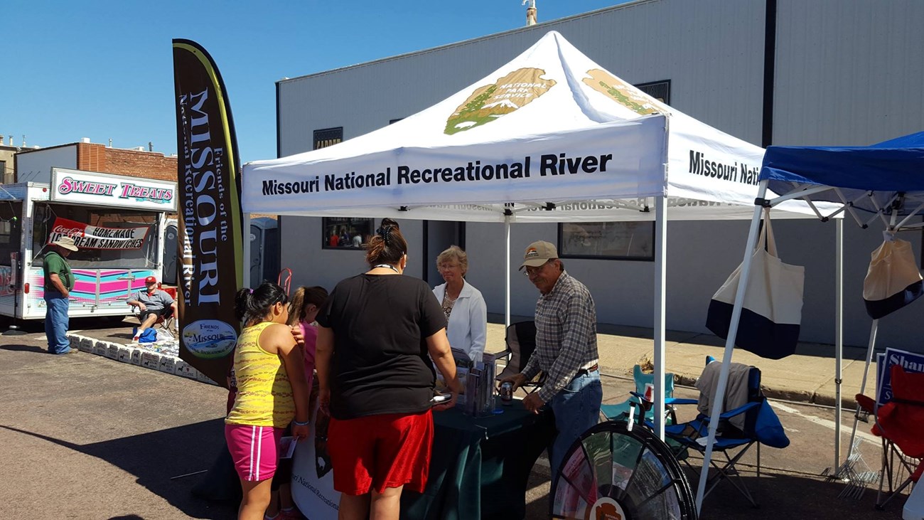 Volunteers staffing a park booth.