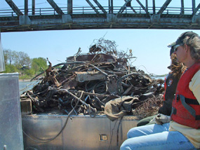 NPS boat brings volunteers and their collected junk under the Meridian Bridge at Yankton. NPS boat brings volunteers and their collected junk under the Meridian Bridge at Yankton.