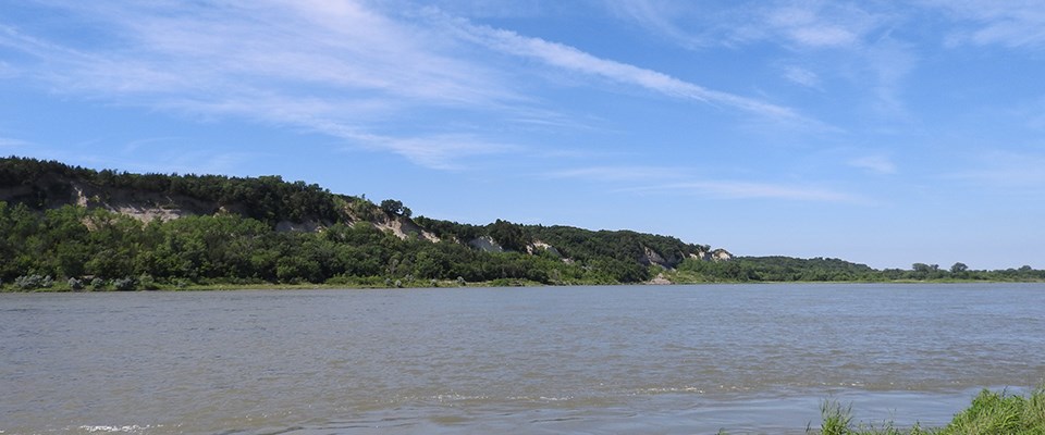 View of river bluffs of Nebraska from the Myron Grove River Access. The natural features of the Missouri National Recreational River include scenic views of river bluffs.
