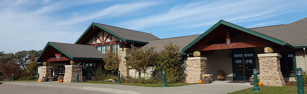 Single story building with wood and brick against a blue sky.