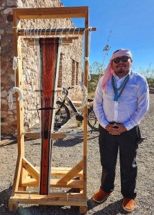 Davis Maho standing next to loom